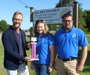 All Sky Energy's float - complete with solar panel and commercial-grade fan - was named the best commercial entry in the July 20 Big Top Parade. Here, Baraboo Area Chamber of Commerce Executive Director Darren Hornby (left) presents a trophy to All Sky owners Lisa and Keith Kahlow.