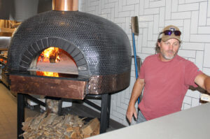 Restaurant owner with wood-fired oven