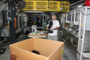 Factory worker makes plastic parts
